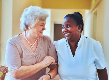 caregiver and her patient chatting while walking together