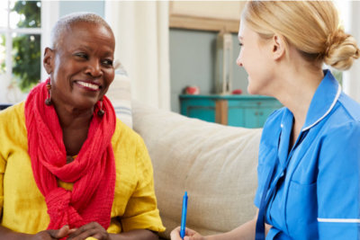 caregiver talking with the senior woman smiling