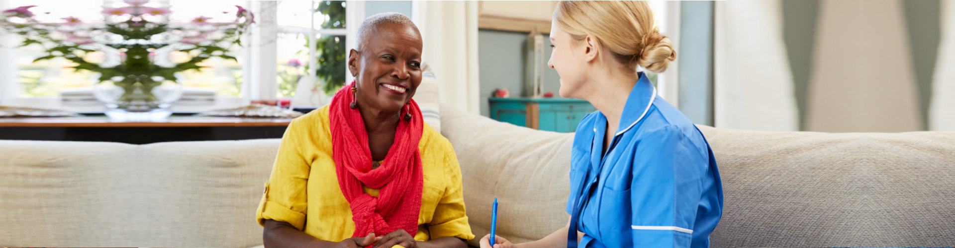 caregiver talking with the senior woman smiling